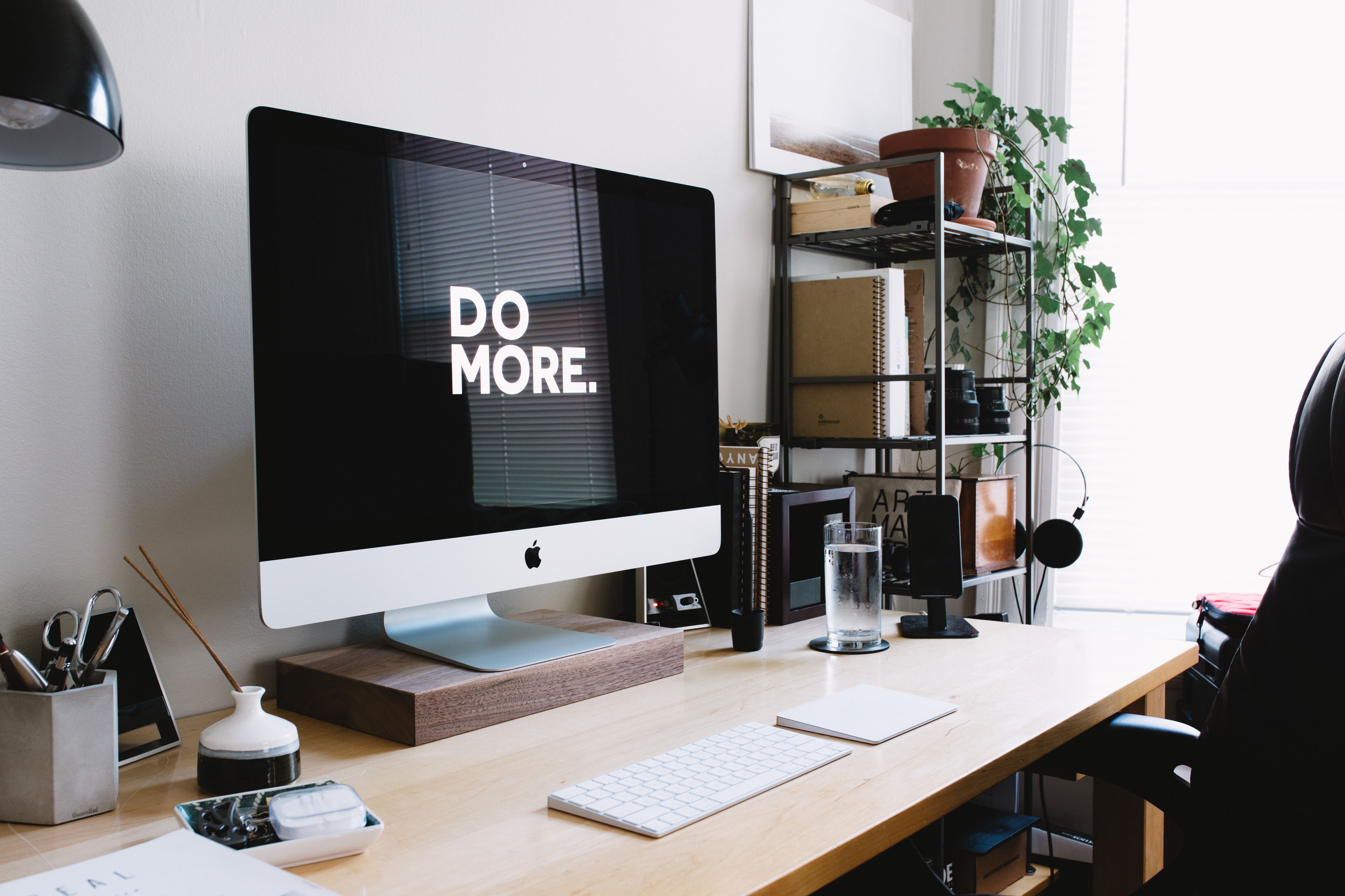 An otherwise blank computer screen reads in large, friendly letters DO MORE.