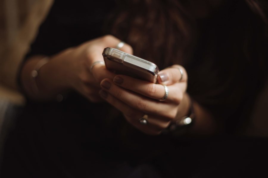 Close up of a woman’s hands using a smart phone