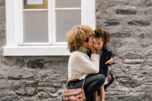 Mother whispering to her daughter