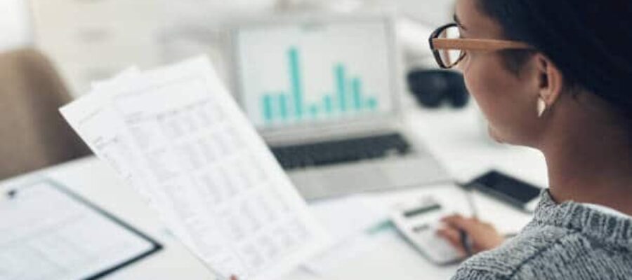Woman holds bookkeeping paperwork