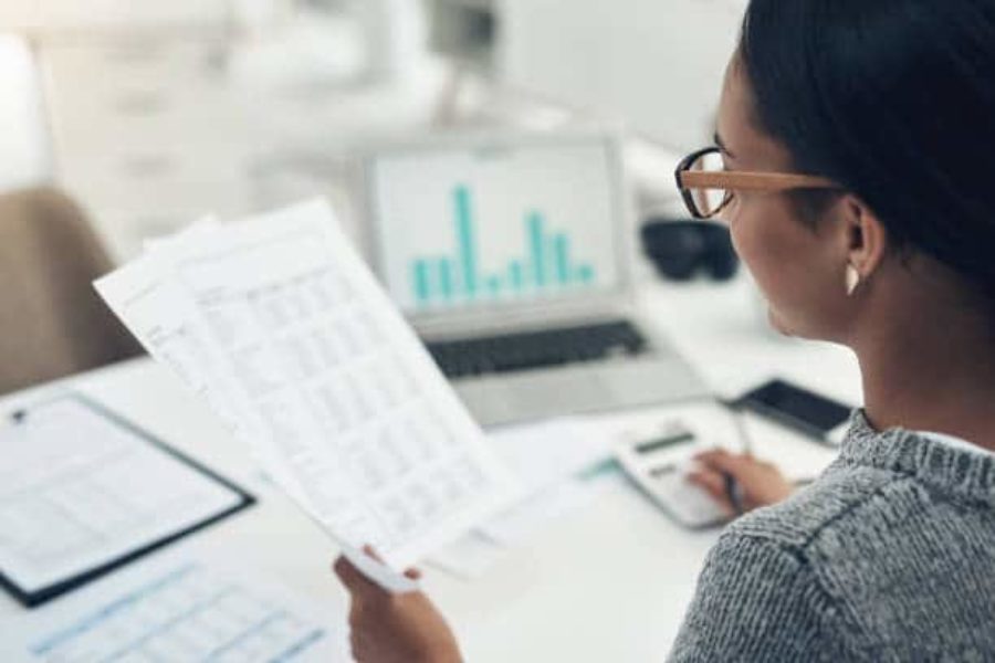 Woman holds bookkeeping paperwork
