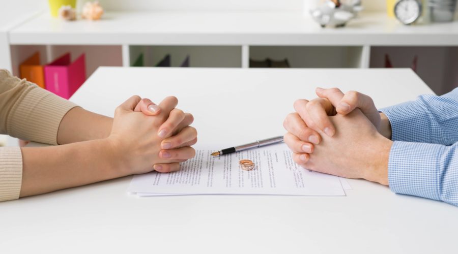 Divorce couples hands on paperwork