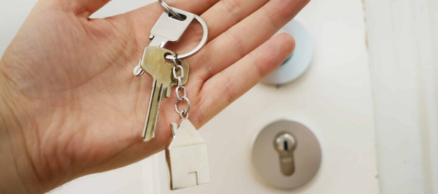Hand holding house keys