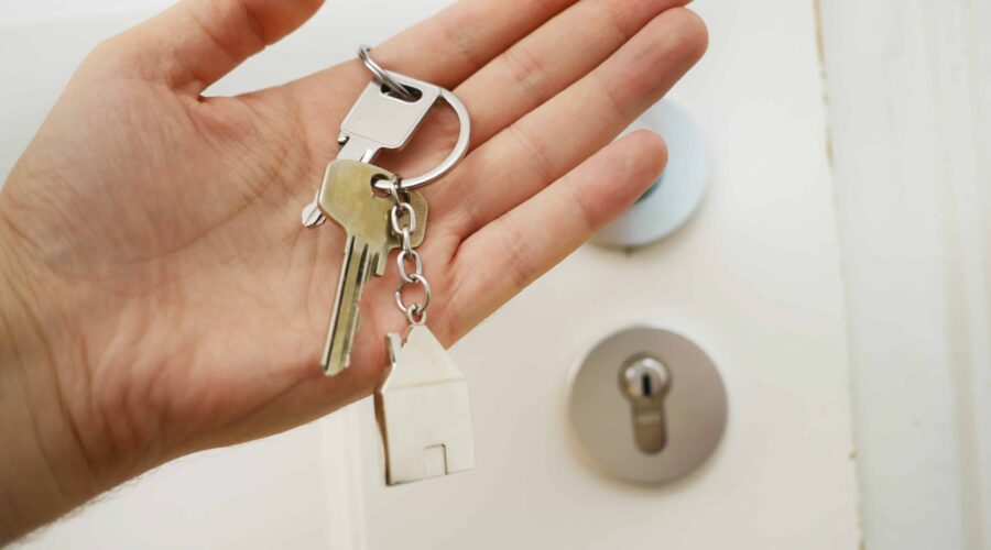 Hand holding house keys
