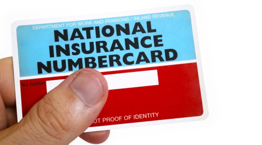 Fingers,Of,A,Man,Holding,A,National,Insurance,Number,Card